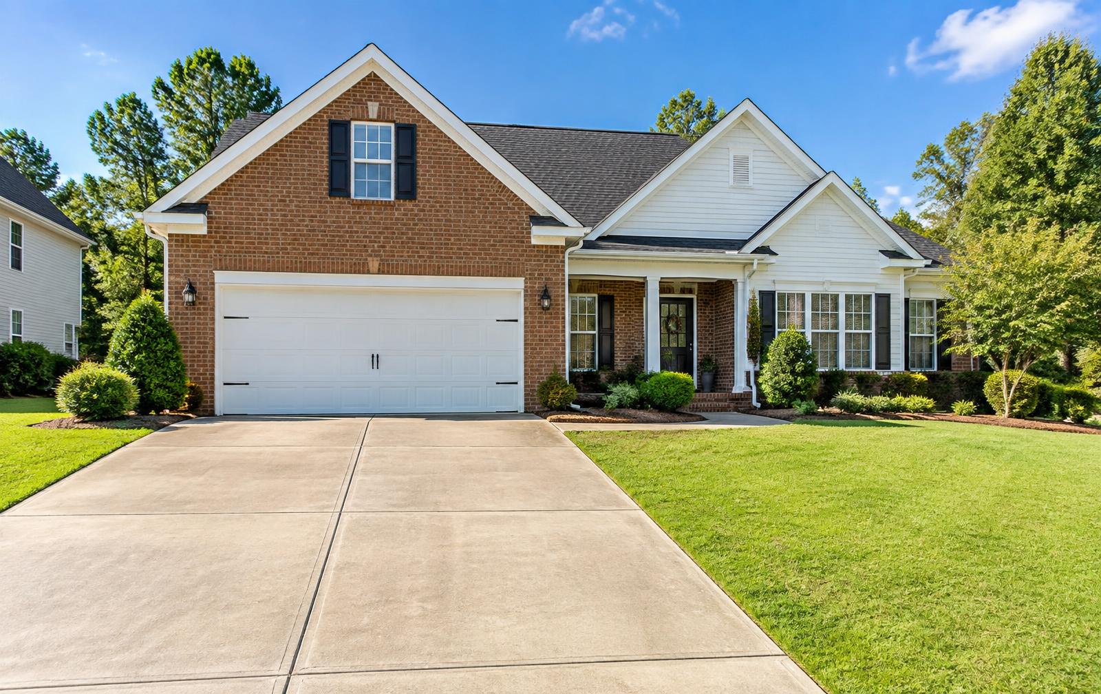 Freshly pressure washed driveway and clean home exterior in Clover, South Carolina